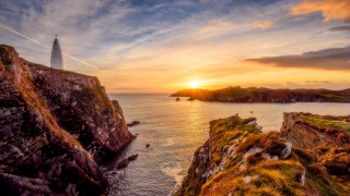 Baltimore Beacon with sun setting over Sherkin Island, West Cork
